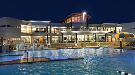 Community center building with outdoor swimming pool.