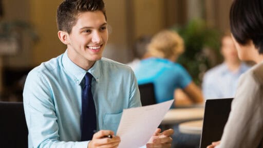 Young professional college student with resume at job interview