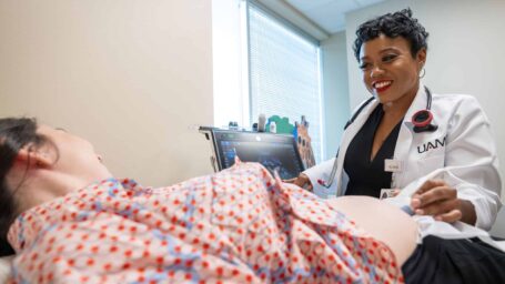 C’Asia James MD performing an ultrasound on a pregnant patient