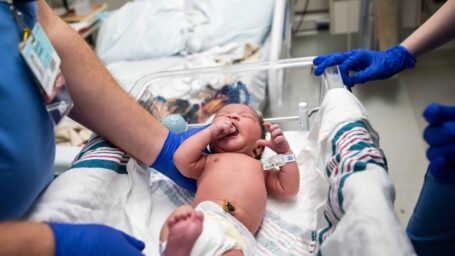 Newborn being examined by UAMS physicians