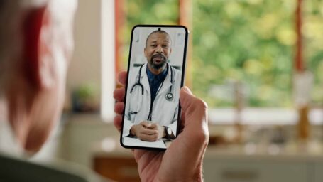 Man, cellphone screen and telehealth with doctor or online consultation at home or virtual advice, discussion or diagnosis. Patient, healthcare worker and internet conversation, service or futuristic