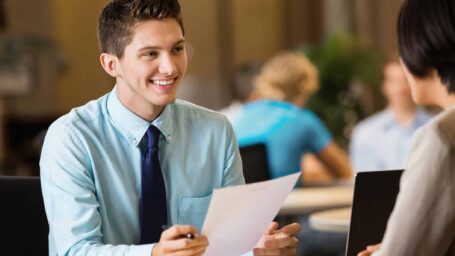 Young professional college student with resume at job interview