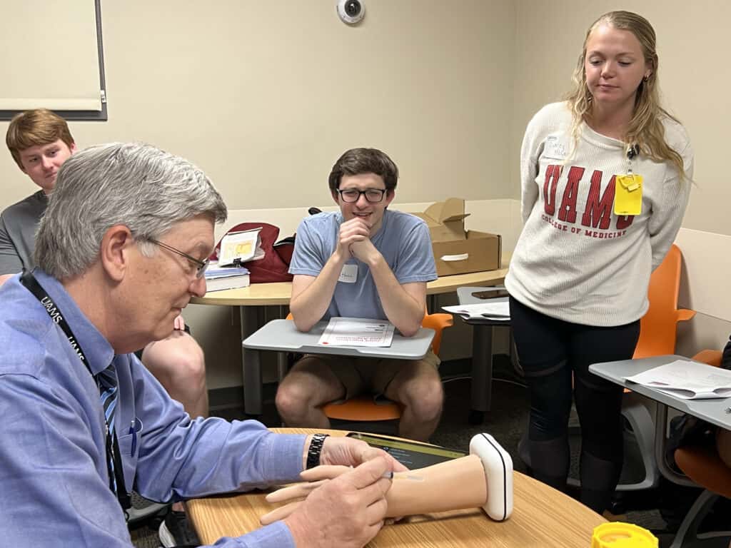 Dr. Downs demonstrating a wrist injection.