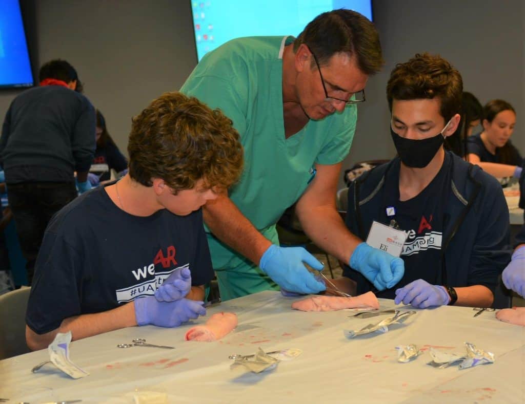 UAMS Northwest MASH. Dr. Wayne Hudec, general surgeon, teaching suture techniques