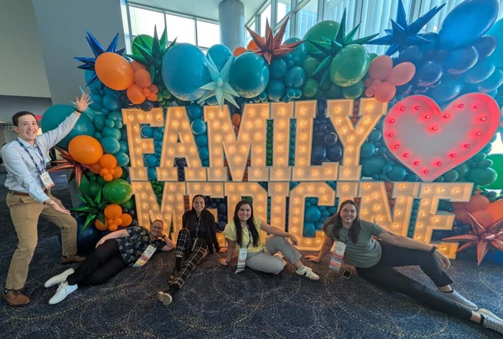 Honors in Underserved in Primary Care students in front of Family Medicine sign