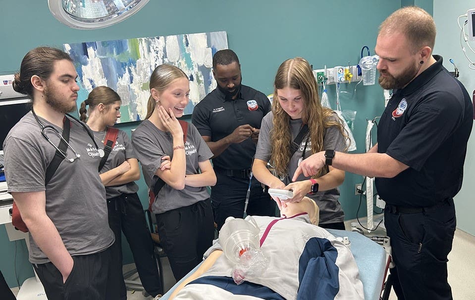 Cabot MASH students watching an intubation on a medical mannequin