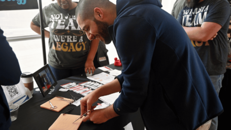 potential residents visiting a booth at the resident fair