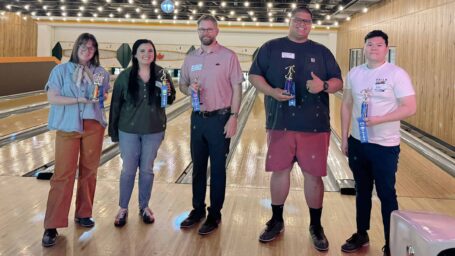 Honors in Underserved Primary Care program participants show off their bowling trophies